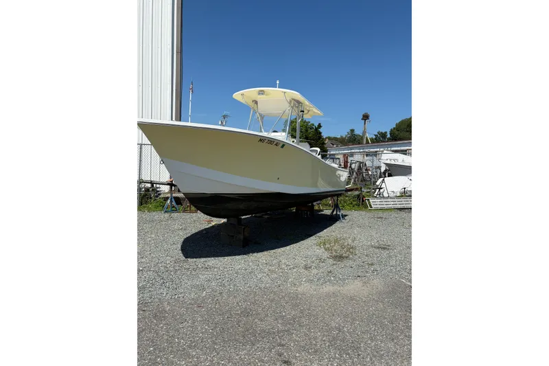 Slide: The Image of 2008 Regulator 23 Forward Seating boat on dry dock under clear blue sky. - 3