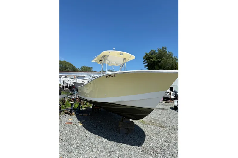 Slide: The Image of 2008 Regulator 23 Forward Seating boat on dry dock under clear blue sky. - 7
