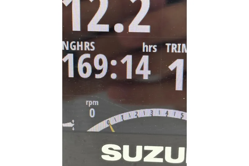 Slide: The Image of Close-up of a Suzuki boat engine display showing 169 hours and 0 RPM. - 11