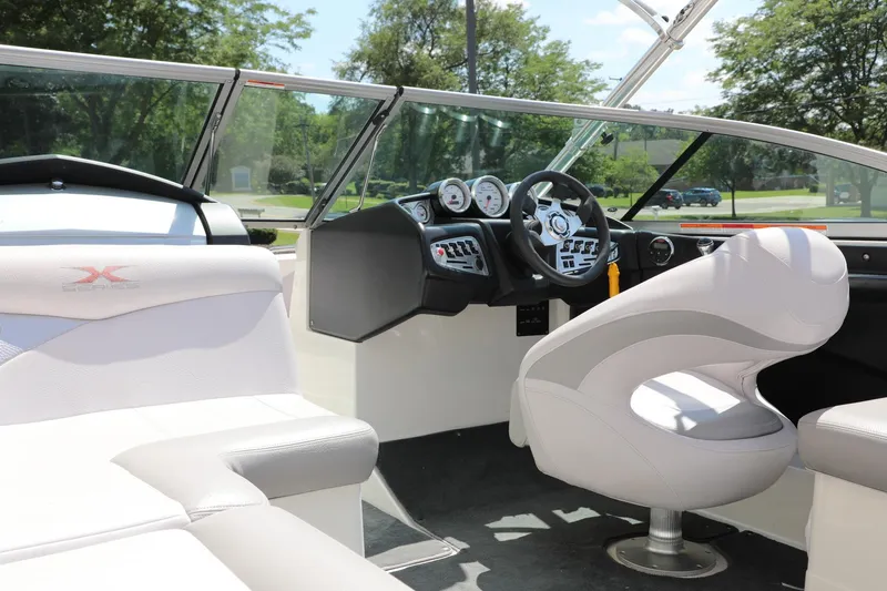 Slide: The Image of Interior of a 2007 MasterCraft X-15 boat, featuring sleek white seating and modern dashboard. - 3