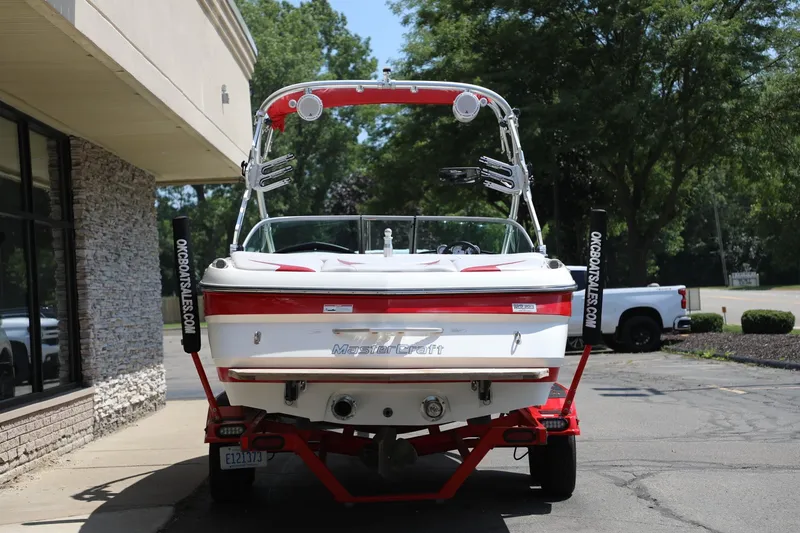 Slide: The Image of 2007 MasterCraft X-15 boat on trailer, parked outside a building. - 2