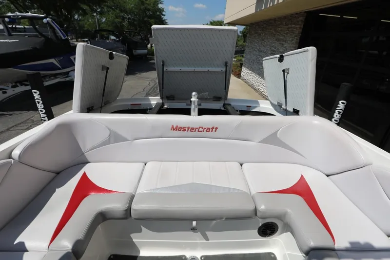 Slide: The Image of 2007 MasterCraft X-15 boat interior with white and red seating, open storage compartments. - 9
