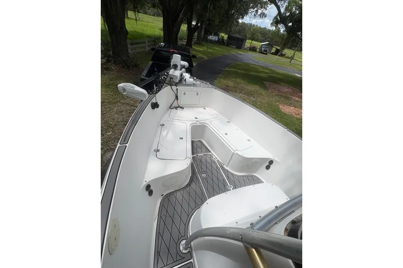 Slide: The Image of 2006 Pro Sports 2550 BW boat interior with seating and equipment, parked on grassy area. - 4