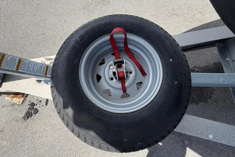 Slide: The Image of Spare tire secured on a trailer, featuring a Pro Sports 2550 BW model from 2006. - 82