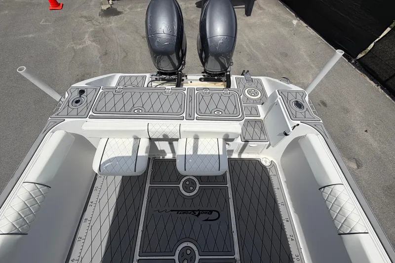Slide: The Image of 2006 Pro Sports 2550 BW boat interior with dual engines and diamond-patterned flooring. - 60