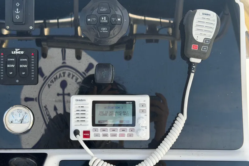 Slide: The Image of Control panel of a 2006 Pro Sports 2550 BW boat with Uniden radio and Lenco controls. - 26