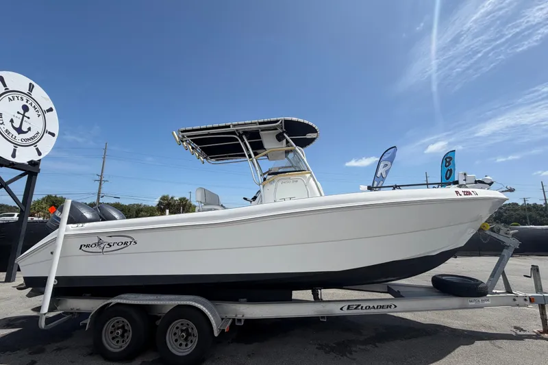 Slide: The Image of 2006 Pro Sports 2550 BW boat on trailer under clear blue sky. - 1