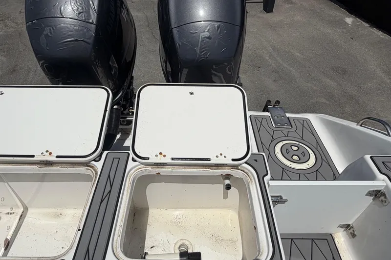 Slide: The Image of Open storage compartments on a 2006 Pro Sports 2550 BW boat deck. - 72