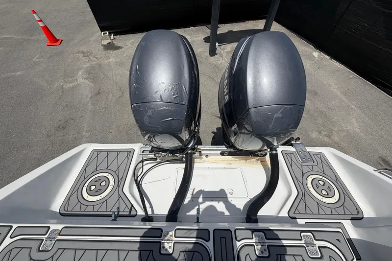 Slide: The Image of Twin Yamaha outboard motors on a 2006 Pro Sports 2550 BW boat, docked on pavement. - 73