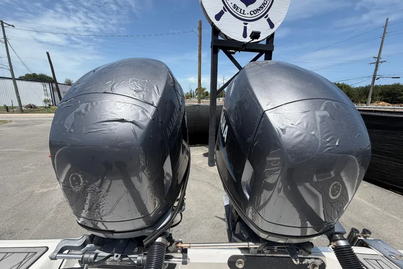 Slide: The Image of Twin Yamaha outboard motors on a 2006 Pro Sports 2550 BW boat, parked outdoors. - 74