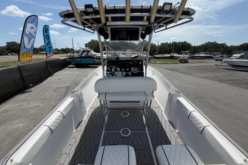 Slide: The Image of 2006 Pro Sports 2550 BW boat interior at dealership, featuring seating and control console. - 14