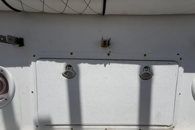 Slide: The Image of 2006 Pro Sports 2550 BW boat compartment with latches and shadows. - 64