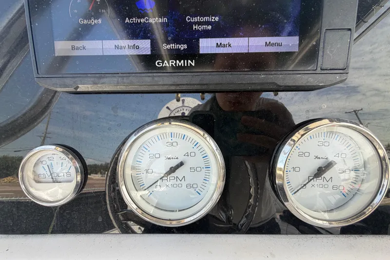 Slide: The Image of Dashboard of a 2006 Pro Sports 2550 BW boat with Garmin display and gauges. - 24