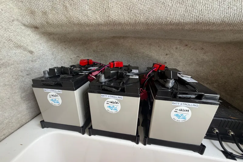 Slide: The Image of Three trolling batteries in a 2006 Pro Sports 2550 BW boat compartment. - 55