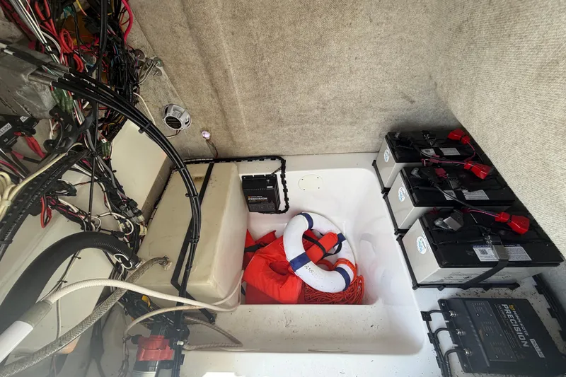 Slide: The Image of Interior of a 2006 Pro Sports 2550 BW boat showing wiring, batteries, and safety equipment. - 54