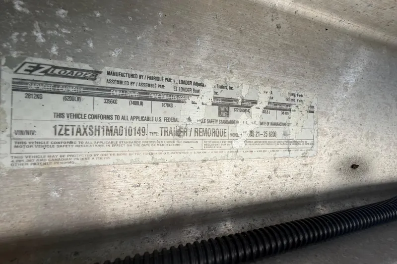 Slide: The Image of Label on EZ Loader trailer, showing VIN and compliance details, Pro Sports 2550 BW, 2006 model. - 79