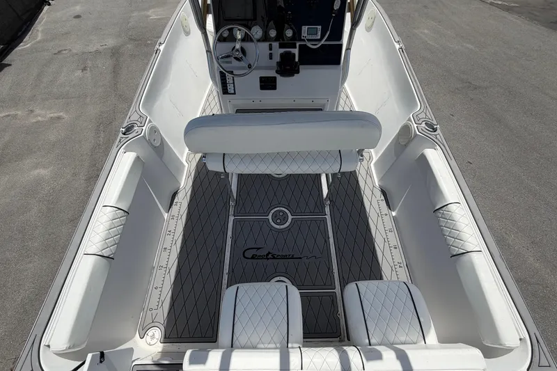 Slide: The Image of 2006 Pro Sports 2550 BW boat interior with white seating and diamond-patterned flooring. - 16