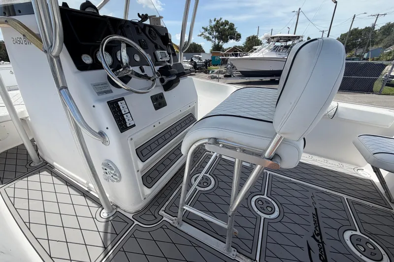 Slide: The Image of 2006 Pro Sports 2550 BW boat interior with steering console and cushioned seating. - 18