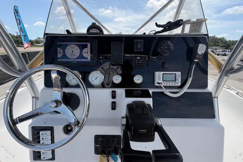 Slide: The Image of Dashboard of a 2006 Pro Sports 2550 BW boat with steering wheel and navigation instruments. - 22