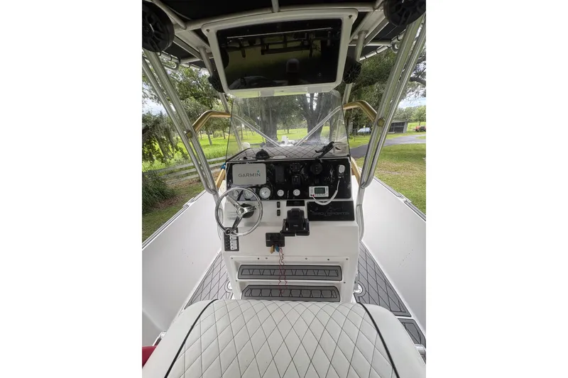 Slide: The Image of 2006 Pro Sports 2550 BW boat dashboard with steering wheel and Garmin navigation system. - 5