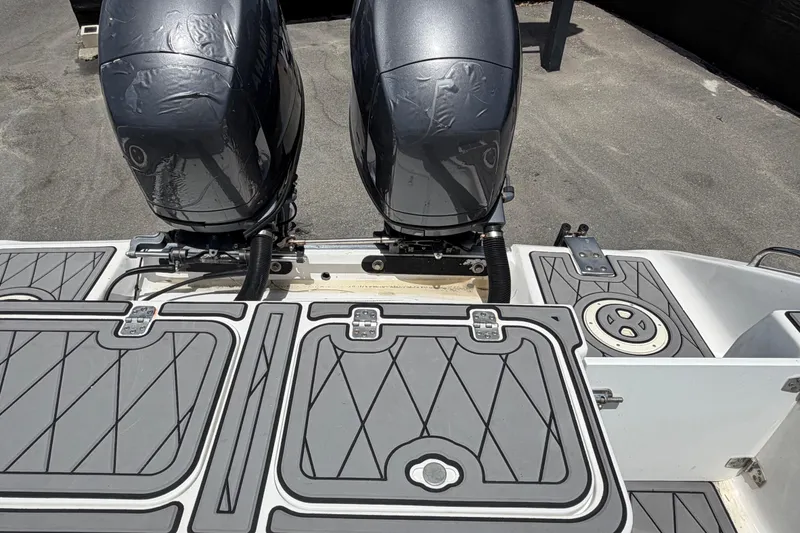 Slide: The Image of Twin outboard motors on a 2006 Pro Sports 2550 BW boat, featuring sleek deck design. - 70