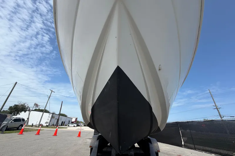 Slide: The Image of 2006 Pro Sports 2550 BW boat hull on trailer, under clear blue sky. - 13