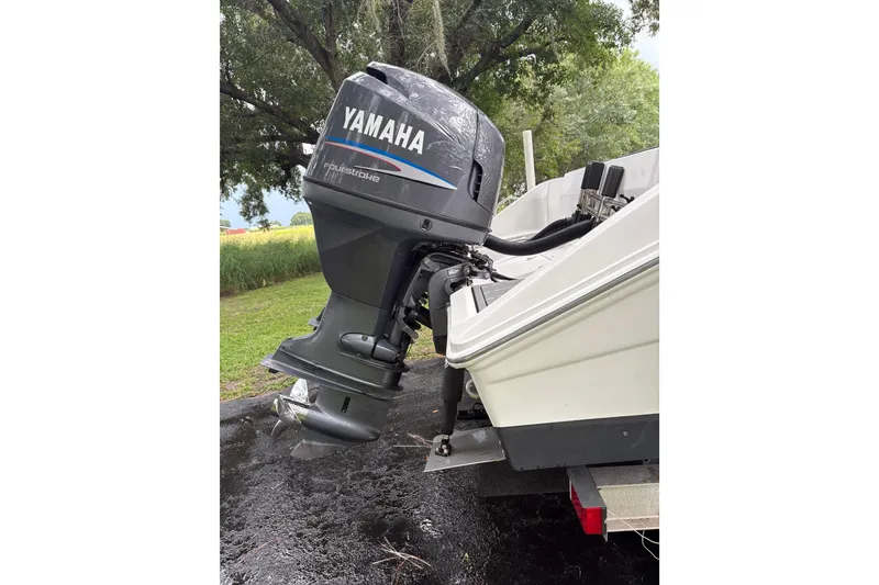 Slide: The Image of 2006 Pro Sports 2550 BW boat with Yamaha outboard motor in a scenic outdoor setting. - 23