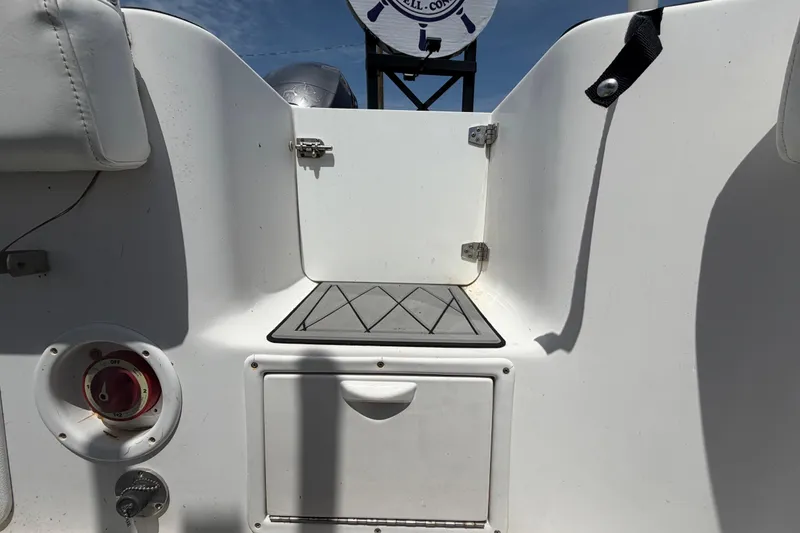 Slide: The Image of 2006 Pro Sports 2550 BW boat interior with storage compartment and control panel. - 66