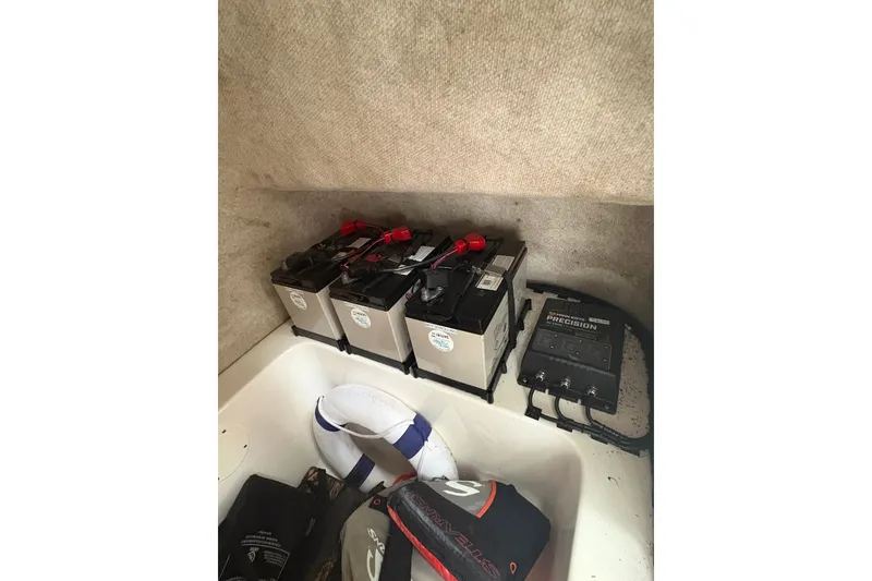 Slide: The Image of Battery compartment of 2006 Pro Sports 2550 BW boat with charger and equipment. - 19