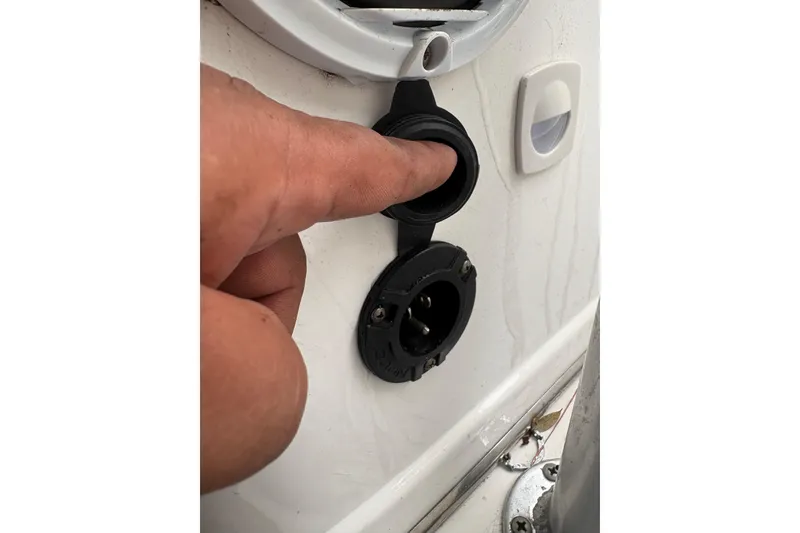 Slide: The Image of Close-up of a person interacting with a boat's electrical socket, Pro Sports 2550 BW, 2006 model. - 17
