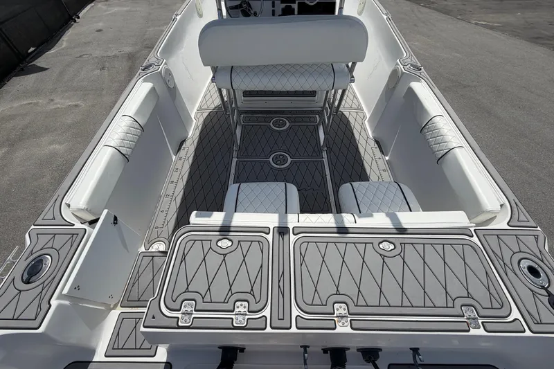 Slide: The Image of Interior view of a 2006 Pro Sports 2550 BW boat, featuring cushioned seating and storage compartments. - 15