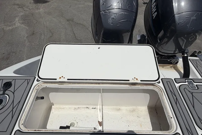 Slide: The Image of Open storage compartment on 2006 Pro Sports 2550 BW boat with dual Yamaha engines. - 71