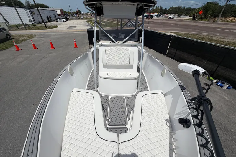 Slide: The Image of 2006 Pro Sports 2550 BW boat with white seating and modern design, parked outdoors. - 48