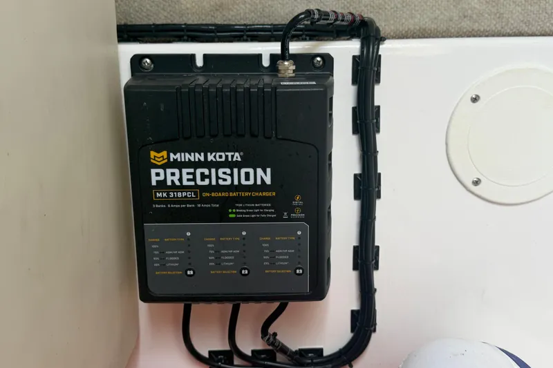Slide: The Image of Minn Kota Precision MK 318PCL on-board battery charger in Pro Sports 2550 BW boat. - 57