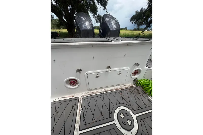 Slide: The Image of 2006 Pro Sports 2550 BW boat deck with dual engines and storage compartments. - 13