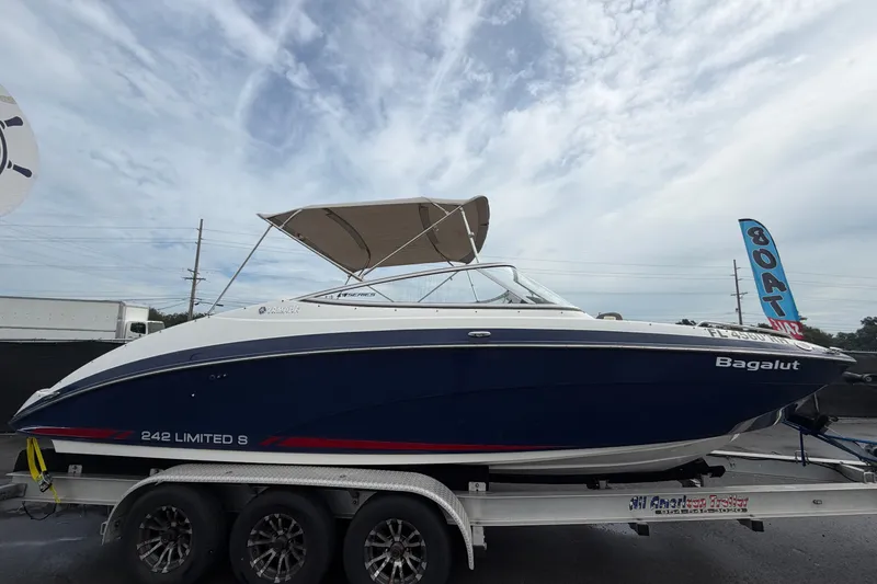 Slide: The Image of 2016 Yamaha Boats 242 Limited S E-Series on trailer under cloudy sky. - 1