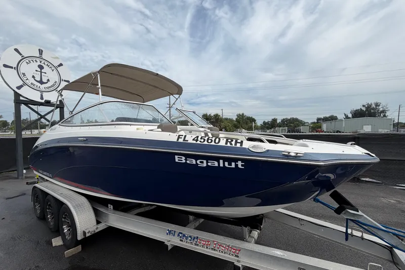 The Image of 2016 Yamaha Boats 242 Limited S E-Series on trailer, blue hull, parked outdoors. - 0