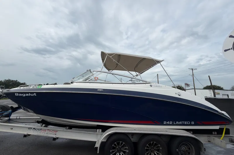 Slide: The Image of 2016 Yamaha Boats 242 Limited S E-Series on trailer, under cloudy sky. - 7