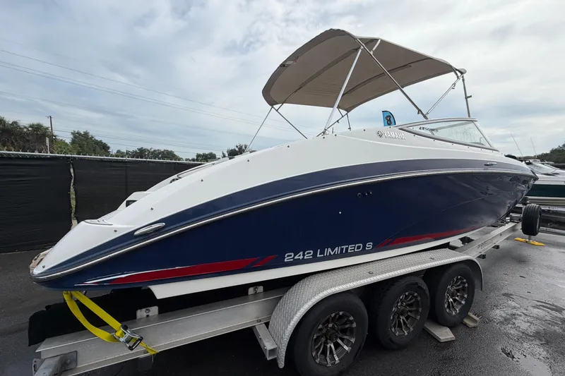 Slide: The Image of 2016 Yamaha Boats 242 Limited S E-Series on trailer, featuring sleek design and canopy. - 2