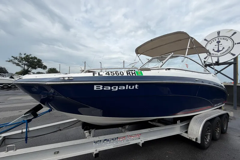 Slide: The Image of 2016 Yamaha Boats 242 Limited S E-Series on trailer, blue hull, parked outdoors. - 8