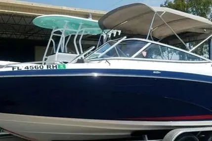 Slide: The Image of 2016 Yamaha Boats 242 Limited S E-Series, blue hull, on trailer, with canopy. - 7