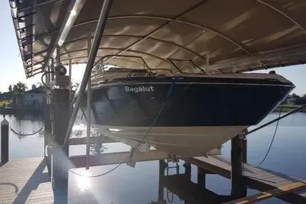 The Image of 2016 Yamaha Boats 242 Limited S E-Series on lift, docked under canopy. - 0
