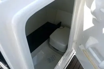 Slide: The Image of 2016 Yamaha Boats 242 Limited S E-Series interior cabin with compact toilet. - 17