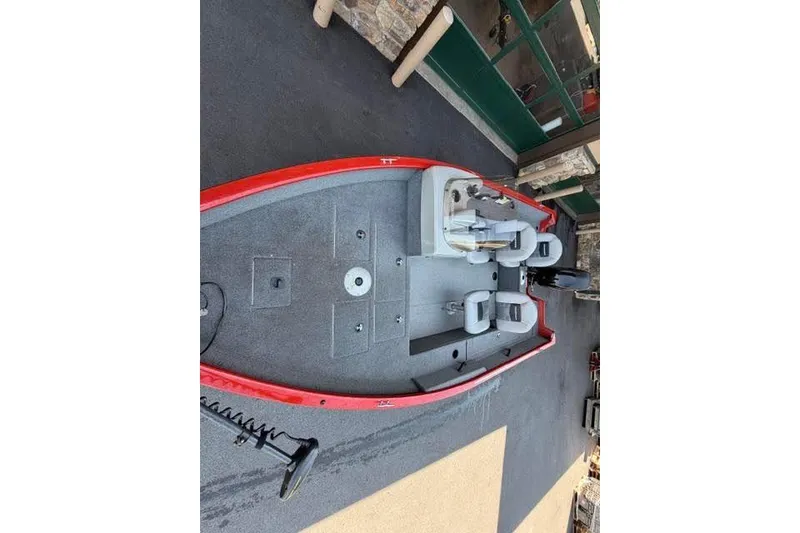 Slide: The Image of 2017 Tracker Pro Guide V-16 SC fishing boat with red exterior and seating arrangement. - 5