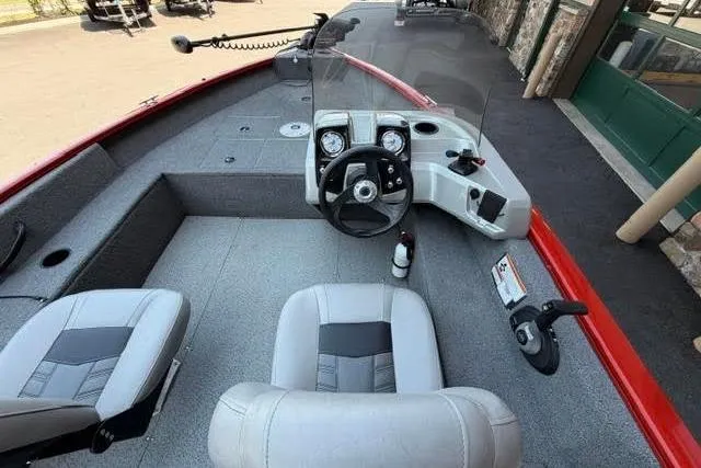 Slide: The Image of 2017 Tracker Pro Guide V-16 SC boat interior with steering console and seating. - 7