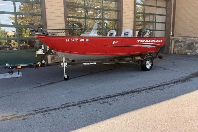 Slide: The Image of 2017 Tracker Pro Guide V-16 SC boat on trailer, parked outside a building. - 8