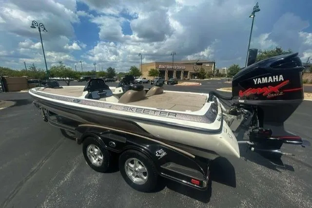 Slide: The Image of 2012 Skeeter 21i boat with Yamaha VMAX engine in parking lot. - 2