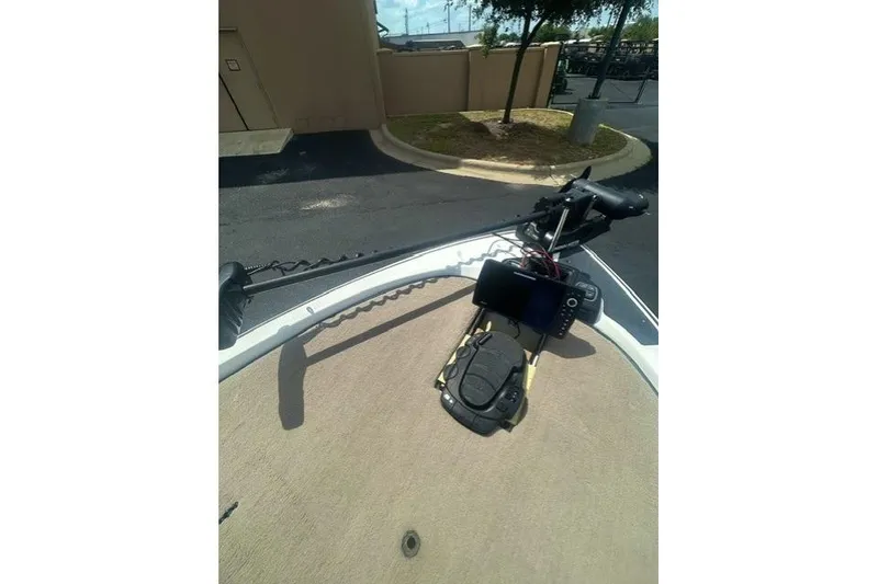 Slide: The Image of 2012 Skeeter 21i boat deck with mounted electronic equipment and trolling motor. - 9
