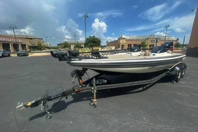 The Image of 2012 Skeeter 21i boat on trailer in parking lot under blue sky. - 0