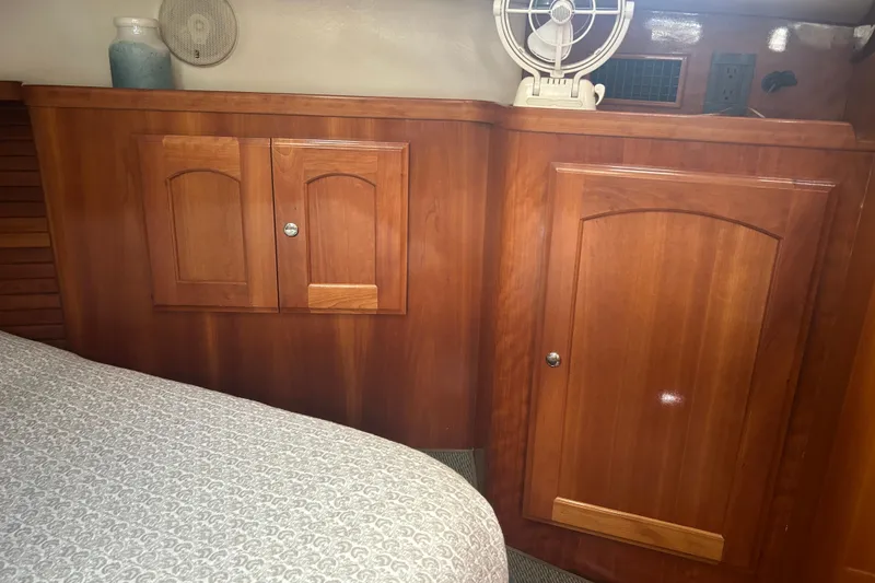 Slide: The Image of Interior of 2007 Legacy EXPRESS CRUISER with wooden cabinets and a small fan. - 22